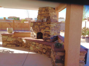 Kiva Fireplace with rock facing in patio by Mountain Paradise Landscaping, Rio Rancho & Albuquerque, New Mexico